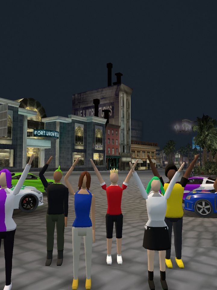 A photo taken with the in-game phone: players cheering between rows of parked cars