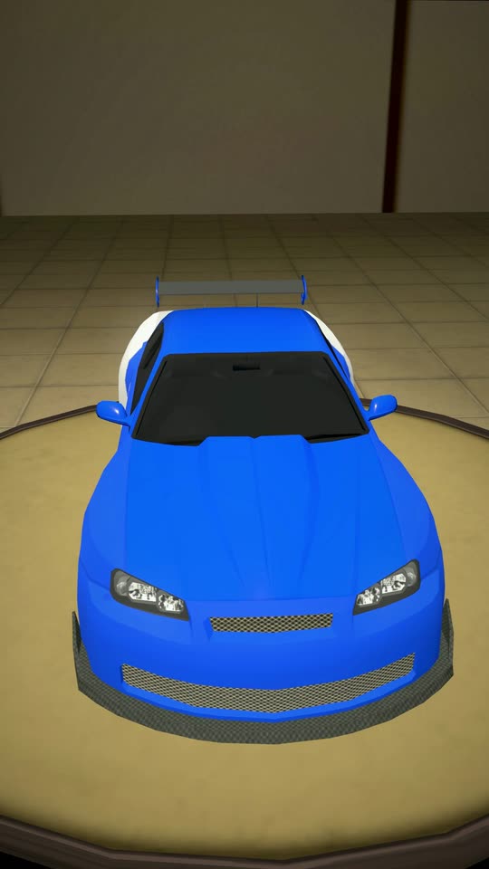 A blue car with a wing on the garage turntable