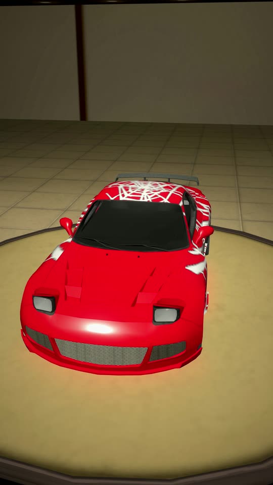 A red car with a web vinyl in the garage