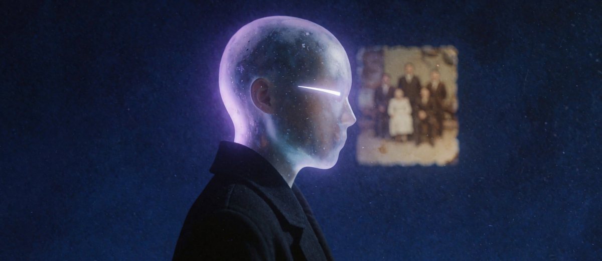 Rejected first design: a figure in profile whose head is translucent glowing glass full of stars, beside an old family photograph