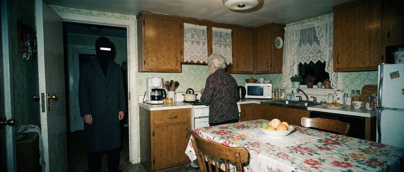 Location master: grandma's kitchen with wood cabinets, lace curtains and a floral tablecloth
